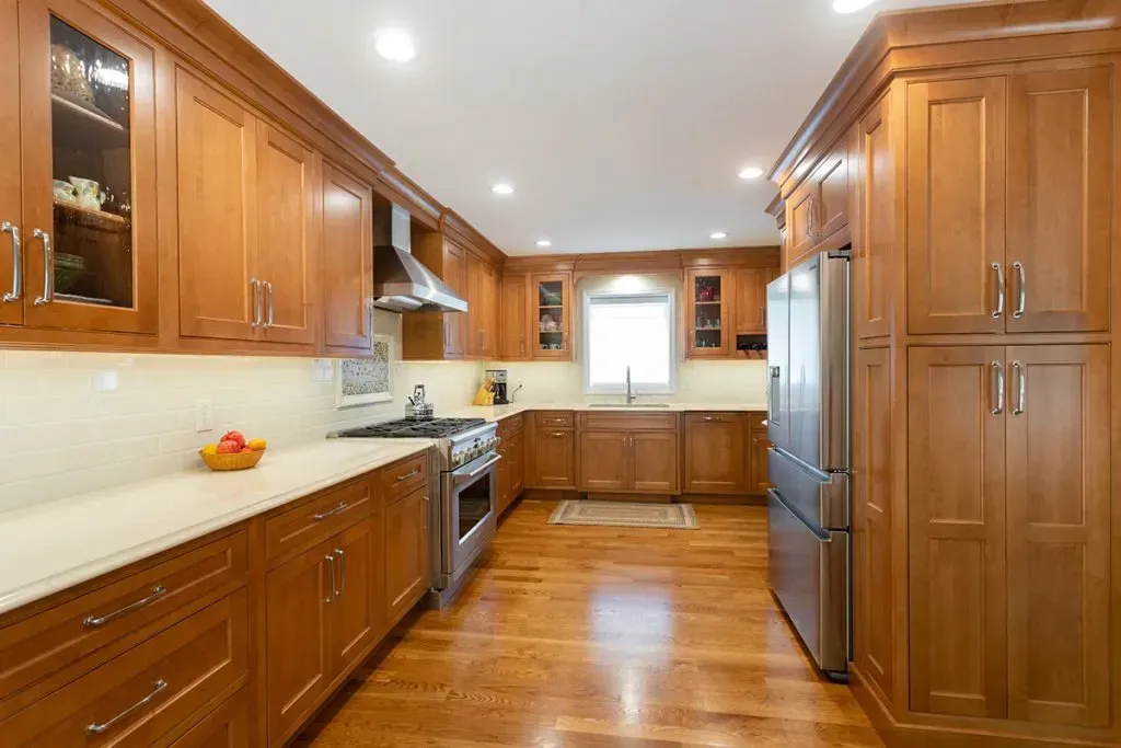 A kitchen with wooden cabinets and stainless steel appliances