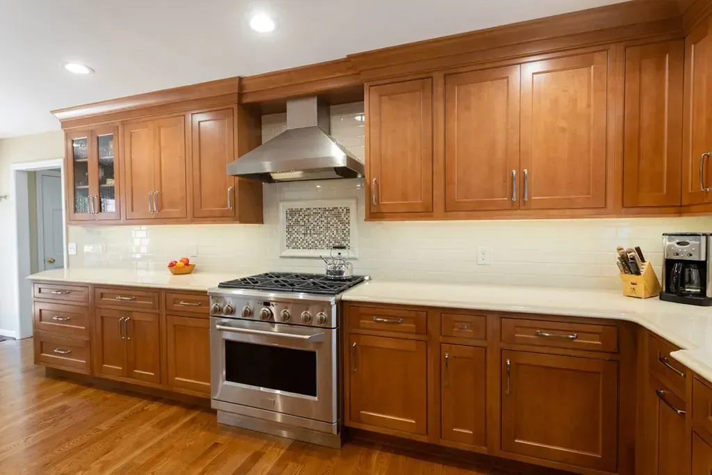 A kitchen with wooden cabinets and stainless steel appliances.