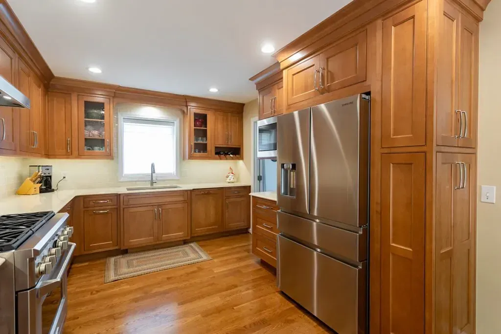 A kitchen with wooden cabinets and stainless steel appliances.