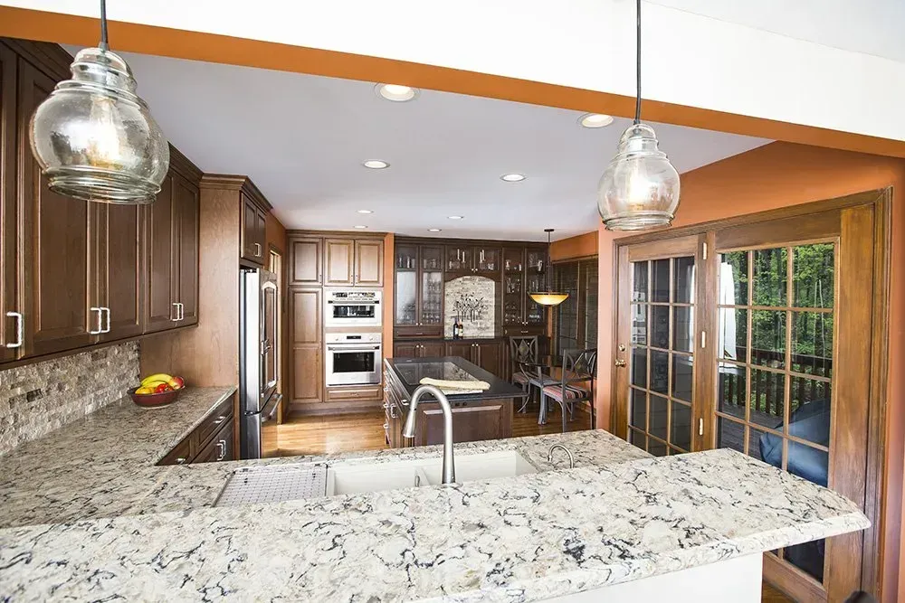 A kitchen with granite counter tops and stainless steel appliances