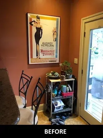 A before picture of a kitchen with a poster for breakfast at tiffany 's