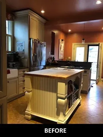 A before picture of a kitchen with a large island in the middle.