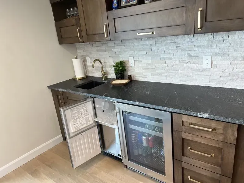 A kitchen with stainless steel appliances and wooden cabinets.