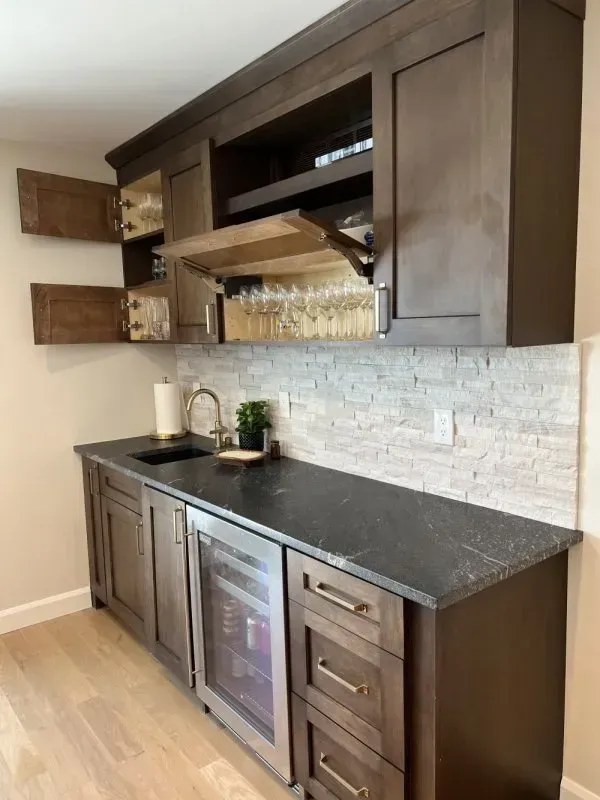 A kitchen with stainless steel appliances , granite counter tops , and wooden cabinets.