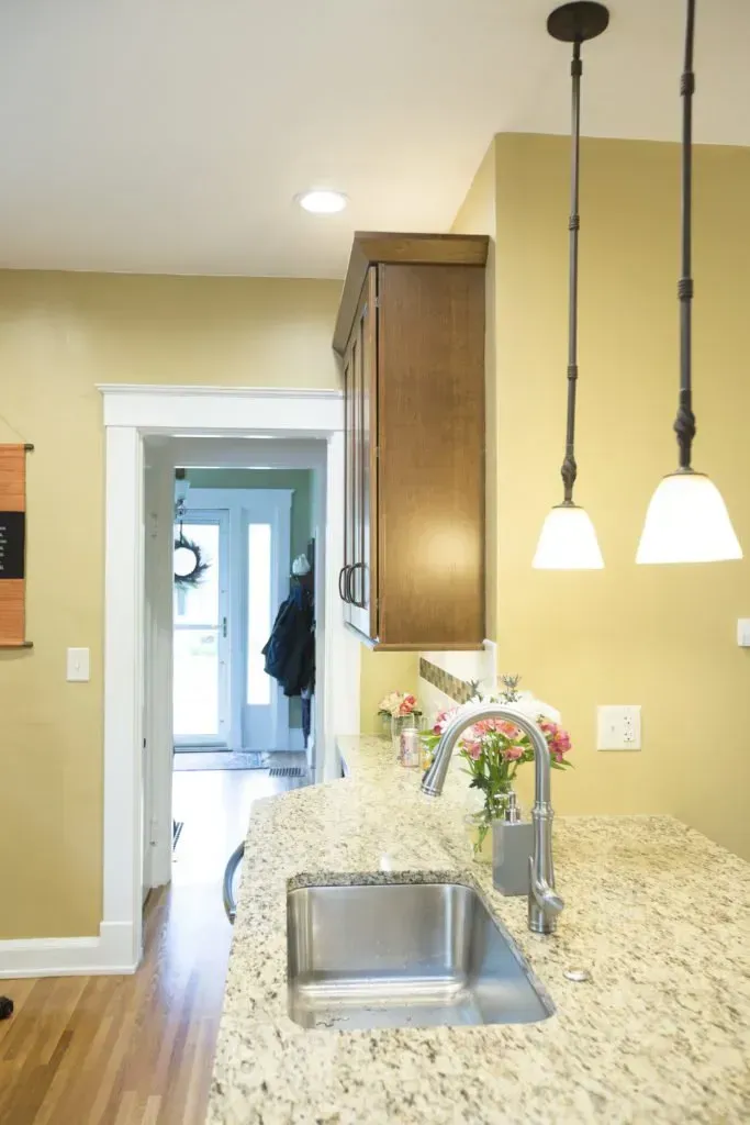 A kitchen with granite counter tops and a stainless steel sink