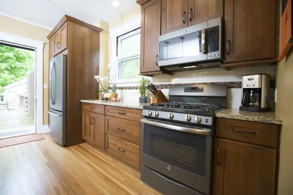 A kitchen with stainless steel appliances and wooden cabinets
