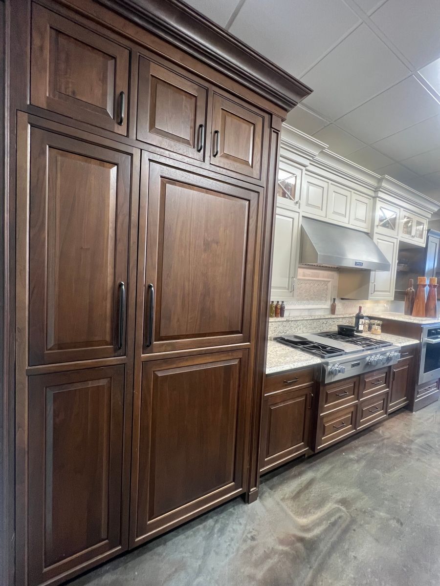 A kitchen with wooden cabinets and a stove top oven