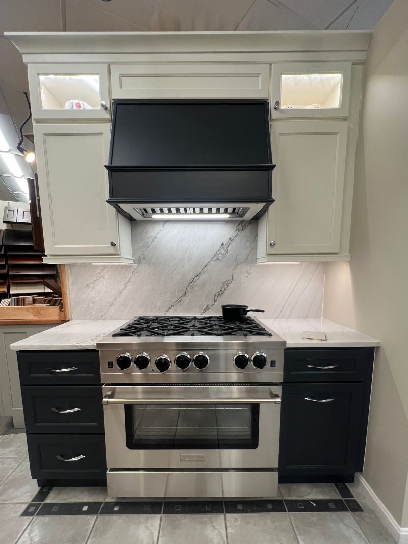 A kitchen with stainless steel appliances and black cabinets