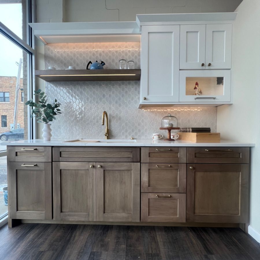 A kitchen with wooden cabinets and white counter tops
