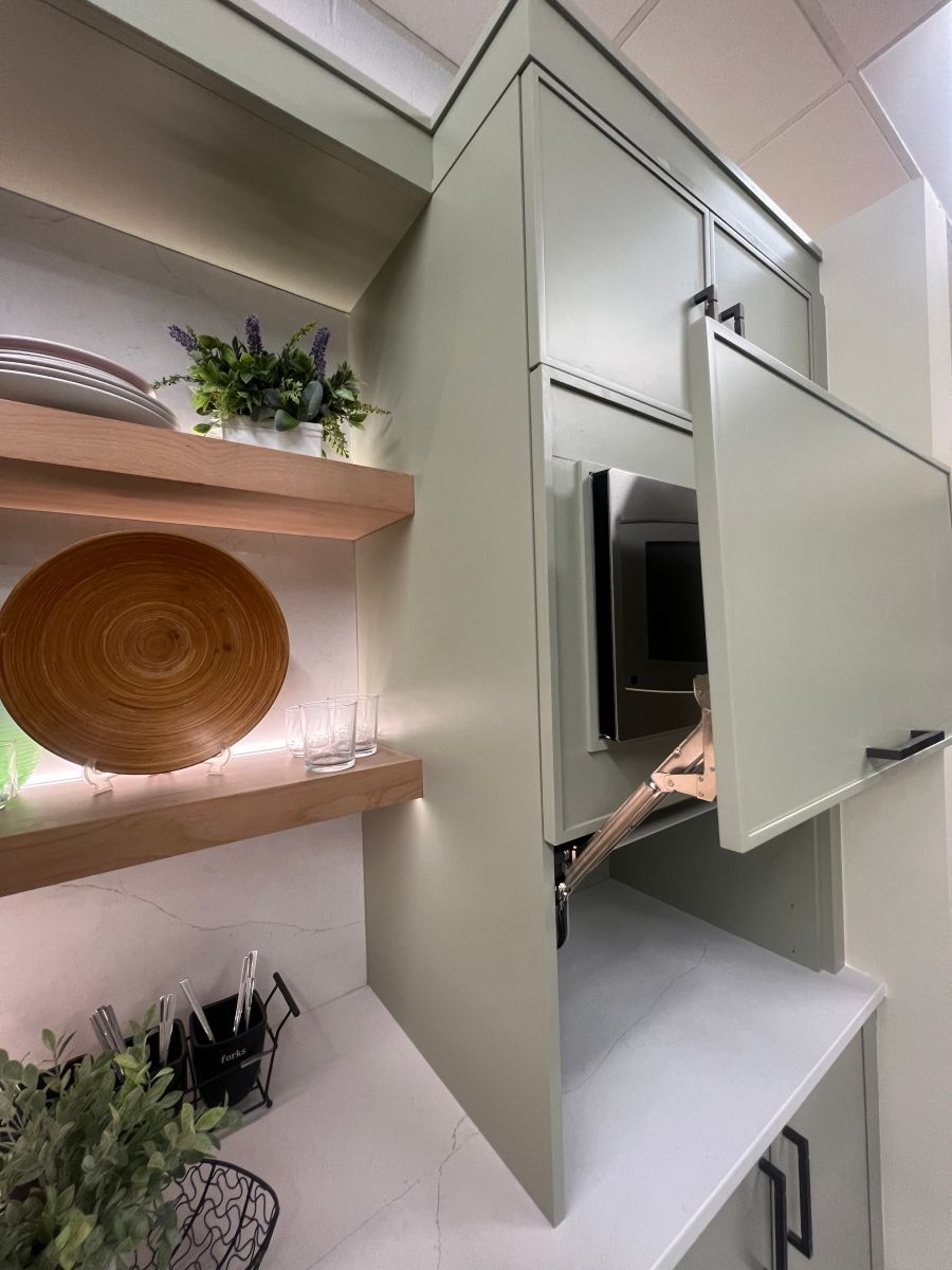 A kitchen with a microwave and a plate on the shelf.