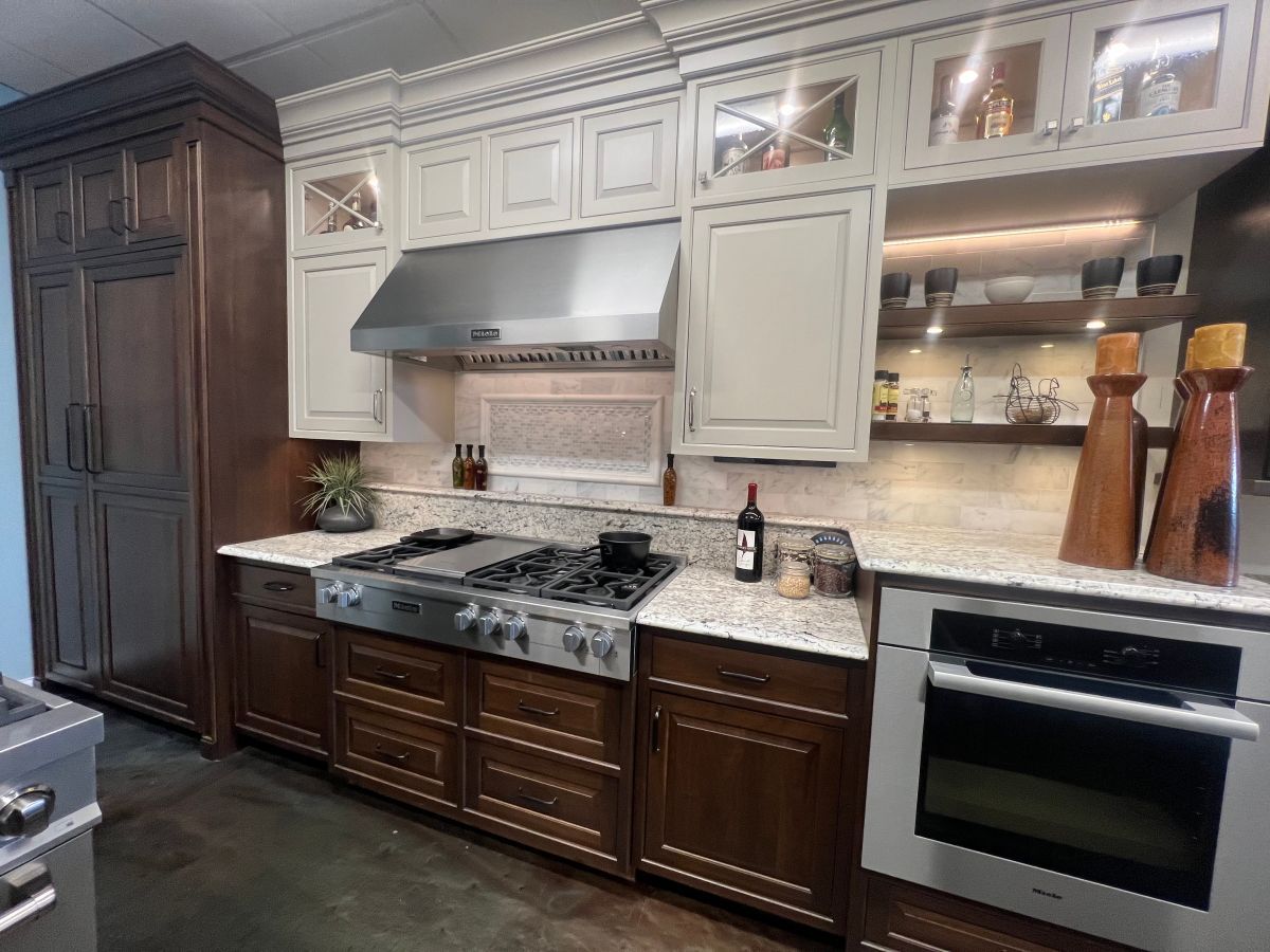 A kitchen with stainless steel appliances and wooden cabinets.