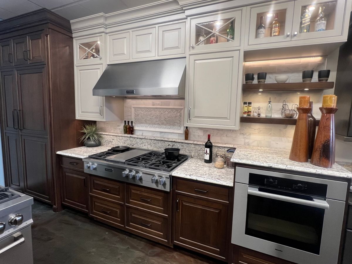 A kitchen with stainless steel appliances and wooden cabinets.