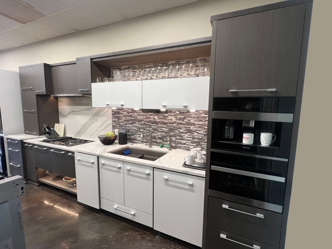 A kitchen with a sink , stove , dishwasher , and oven.