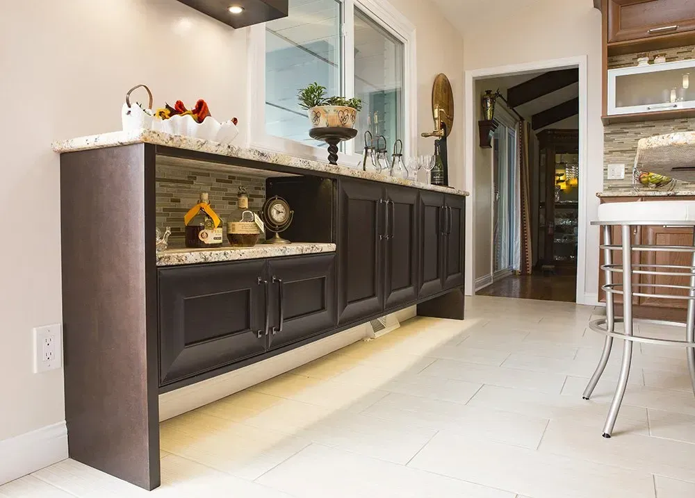 A kitchen with a long counter and a window