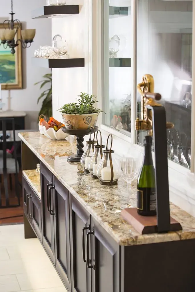 A kitchen counter with a bottle of wine on it