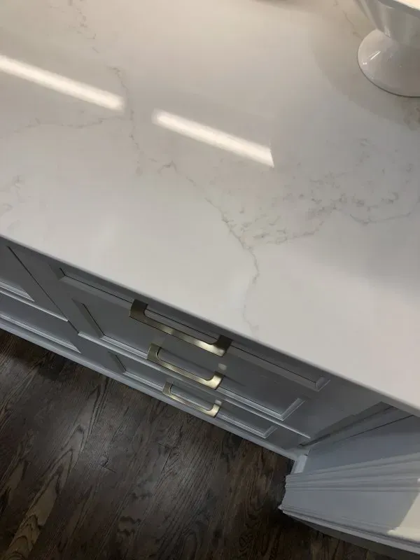 A close up of a white counter top in a kitchen.