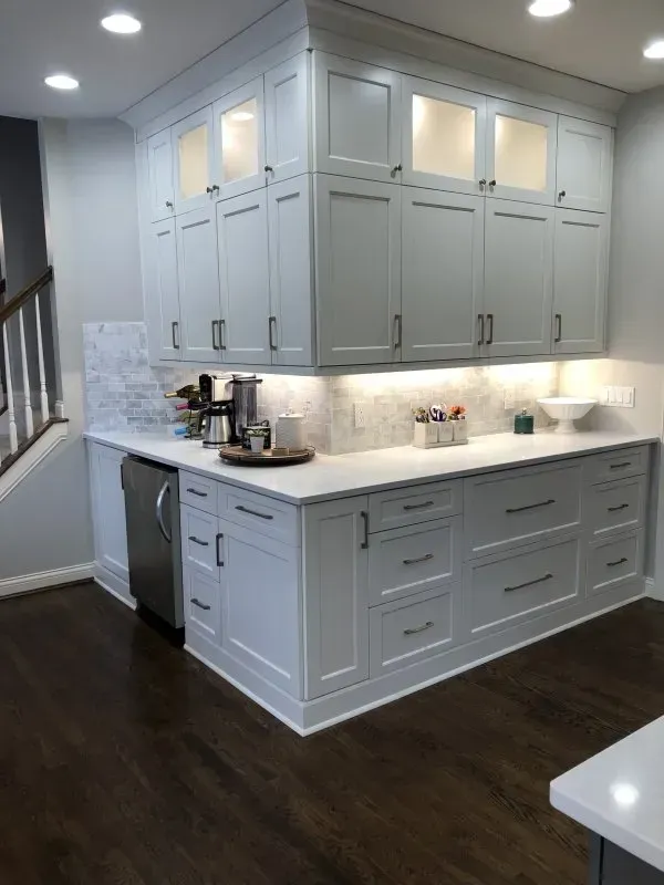 A kitchen with white cabinets and a stainless steel dishwasher.