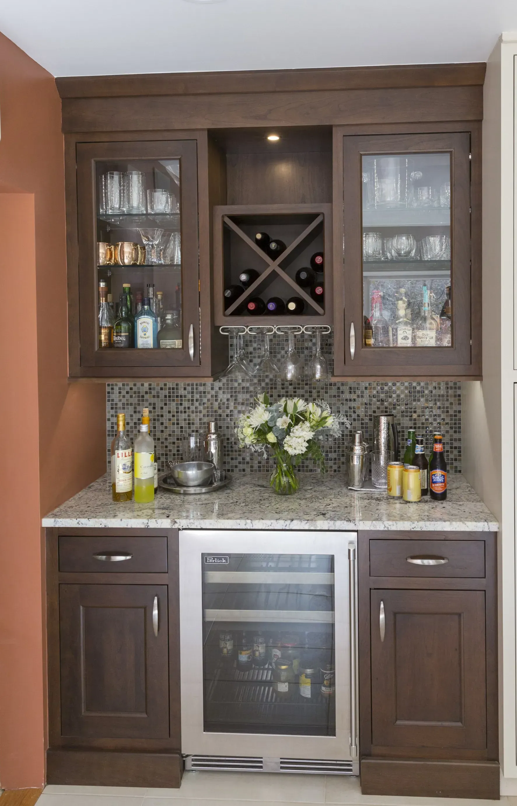 A kitchen with a wine cooler and a wine rack.