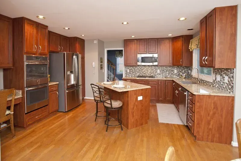A kitchen with wooden cabinets and stainless steel appliances