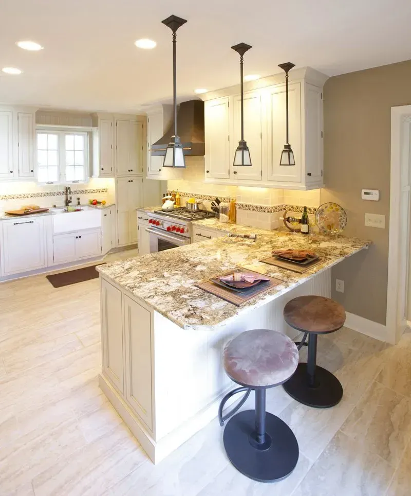 A kitchen with white cabinets and granite counter tops