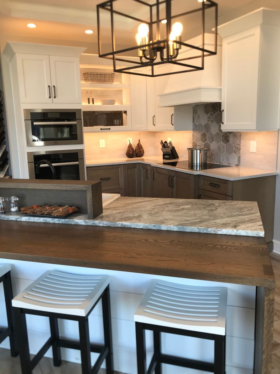 A kitchen with a large island and stools