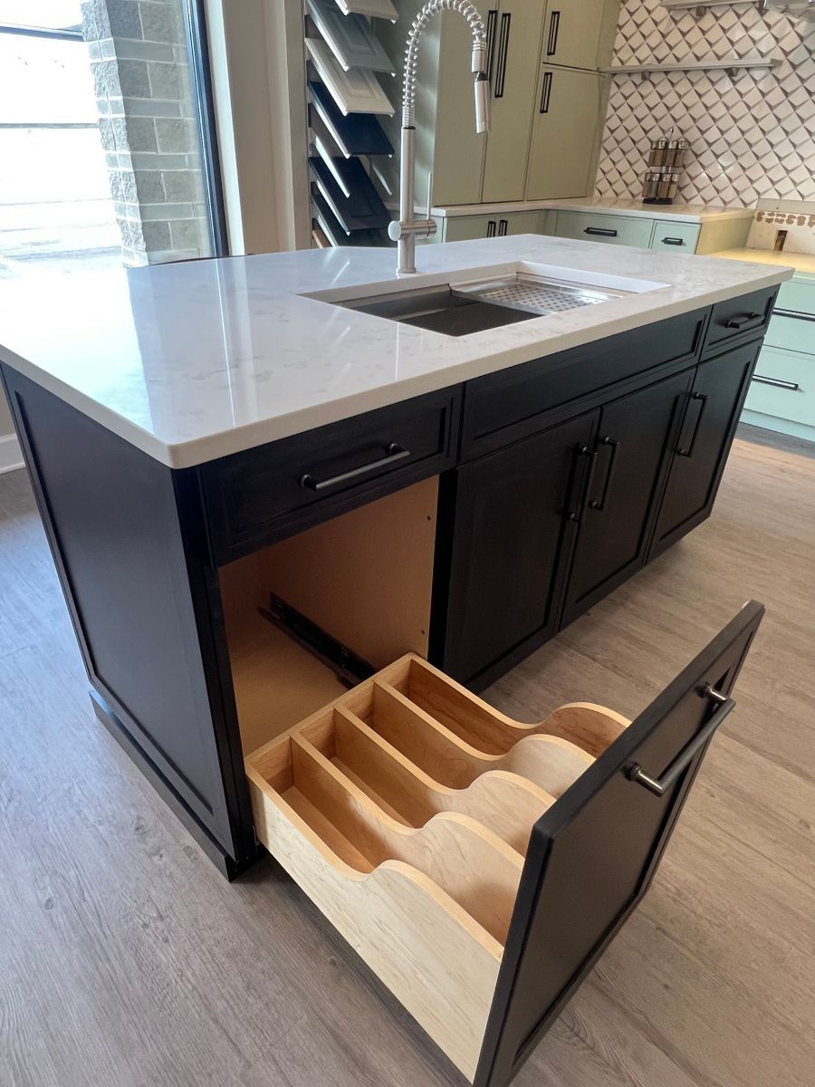 A kitchen island with a drawer open and a sink