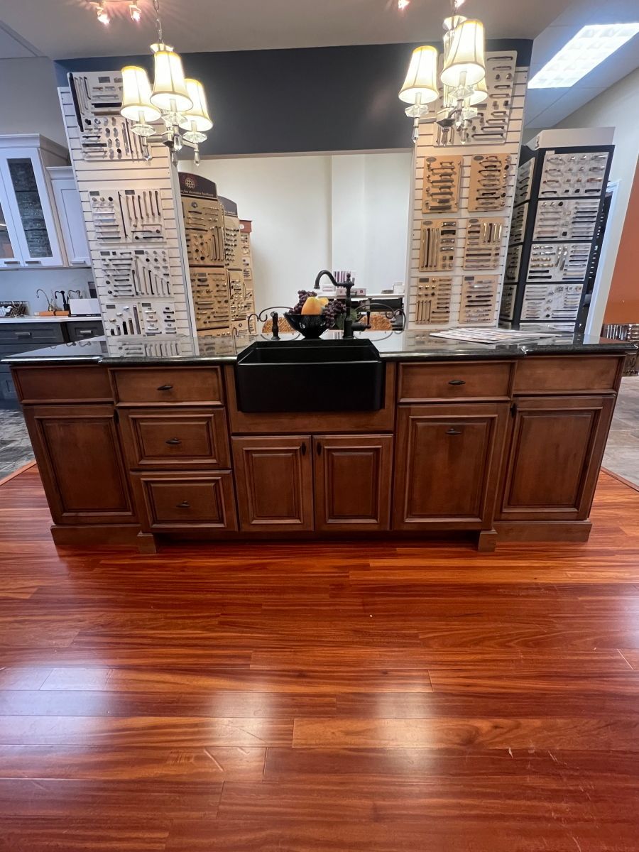 A kitchen with wooden cabinets and a black sink.