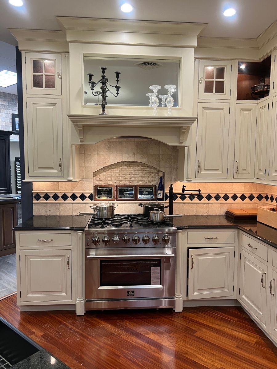 A kitchen with stainless steel appliances and white cabinets
