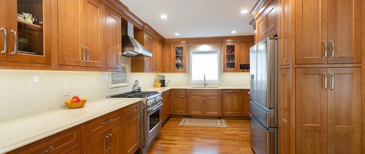 A kitchen with wooden cabinets and stainless steel appliances.