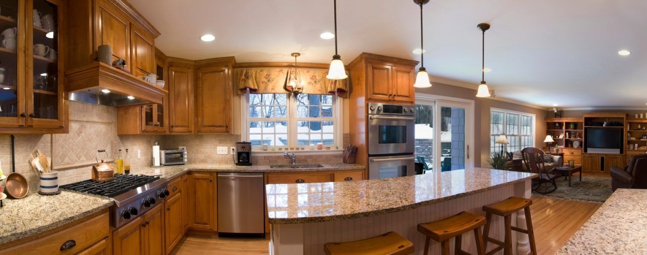 A kitchen with wooden cabinets and granite counter tops