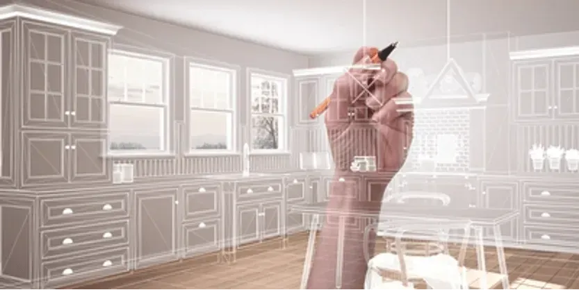 A hand is drawing a kitchen with a pencil.