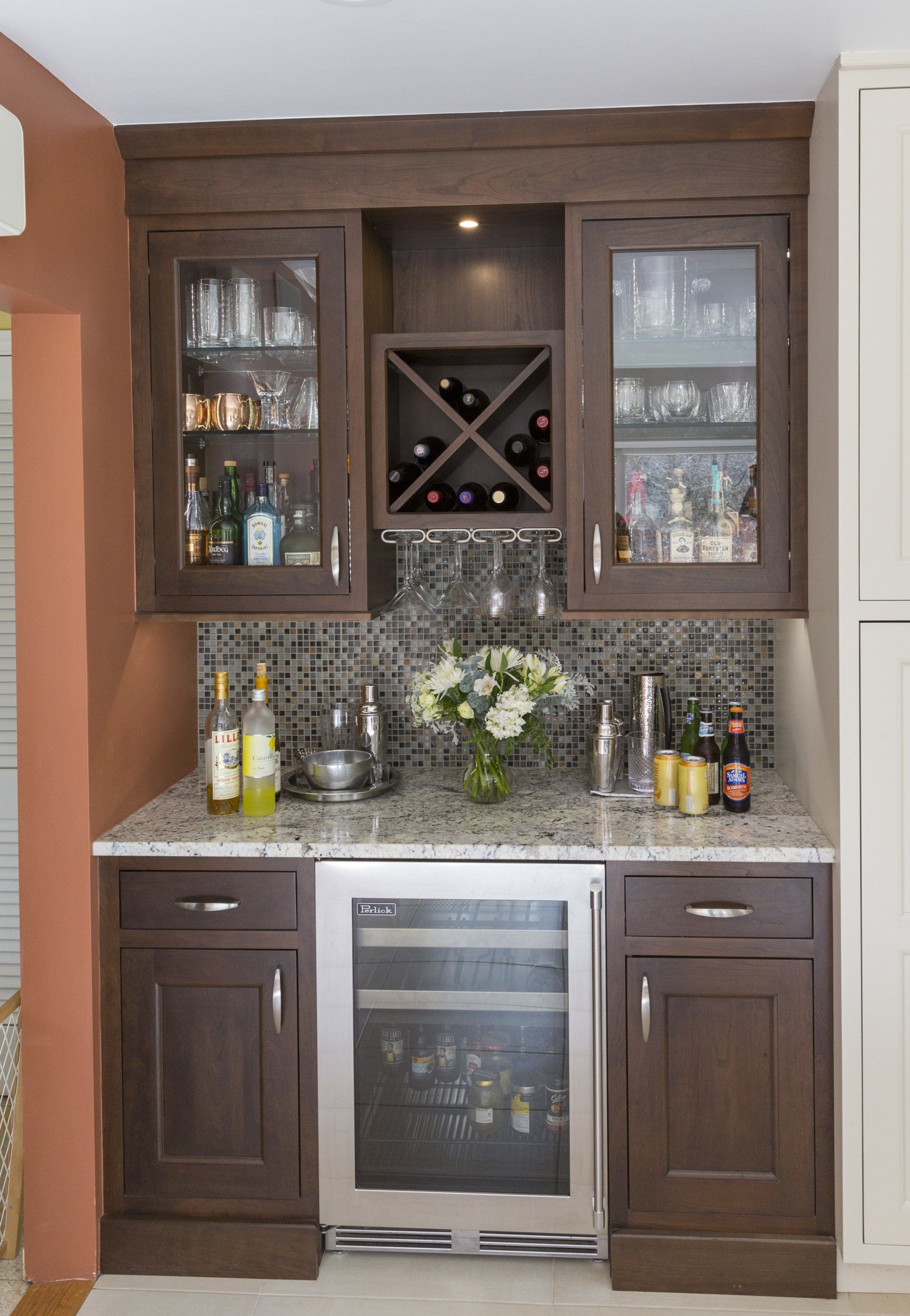 A kitchen with a wine cooler and a wine rack