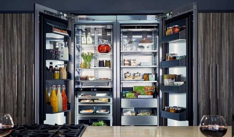 A kitchen with a refrigerator , freezer , and stove.