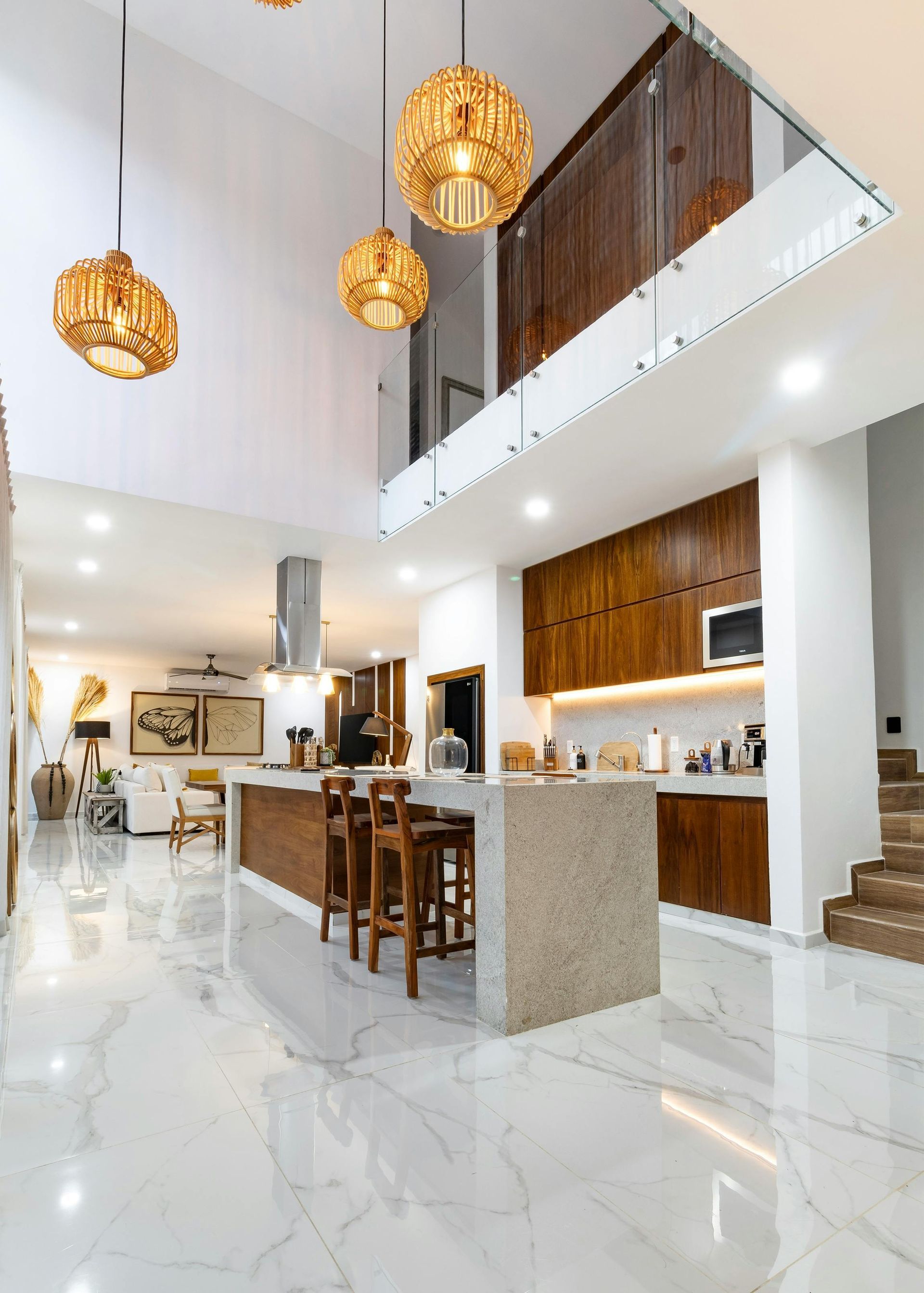 A kitchen with white cabinets , stainless steel appliances , a stove top oven and a refrigerator.