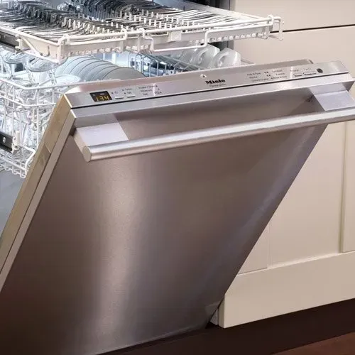 A kitchen with white cabinets and a laptop on the counter.