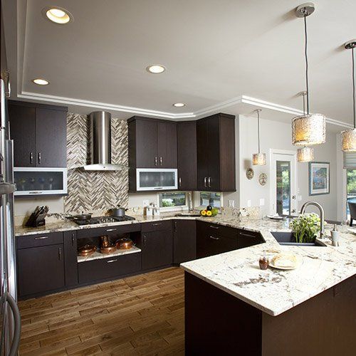 A kitchen with brown cabinets and white counter tops