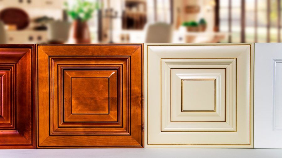 Three different types of cabinet doors are sitting next to each other on a table.