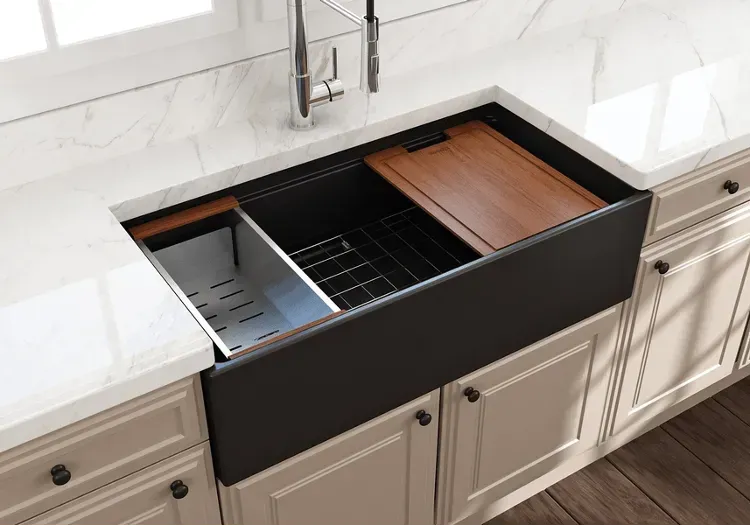 A kitchen sink with a wooden cutting board in it
