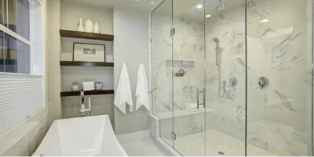 A bathroom with a bathtub and a walk in shower.