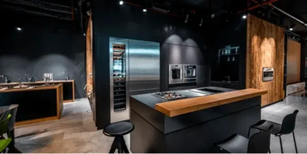 A kitchen with stainless steel appliances and a large island.