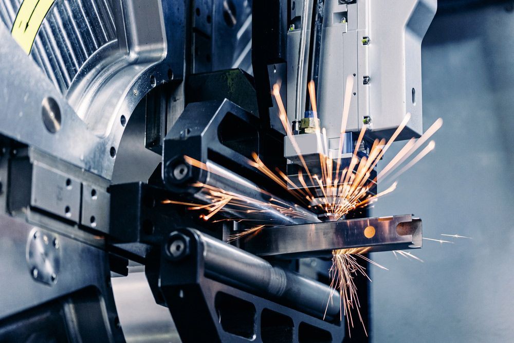 Industrial Machine Cutting Metal, With Sparks Flying in a Workshop — Bryants Laser Works in Brisbane, QLD