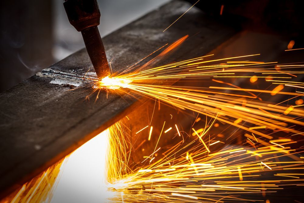 Sparks Flying From a Welding Torch Cutting Through Metal — Bryants Laser Works in Logan, QLD
