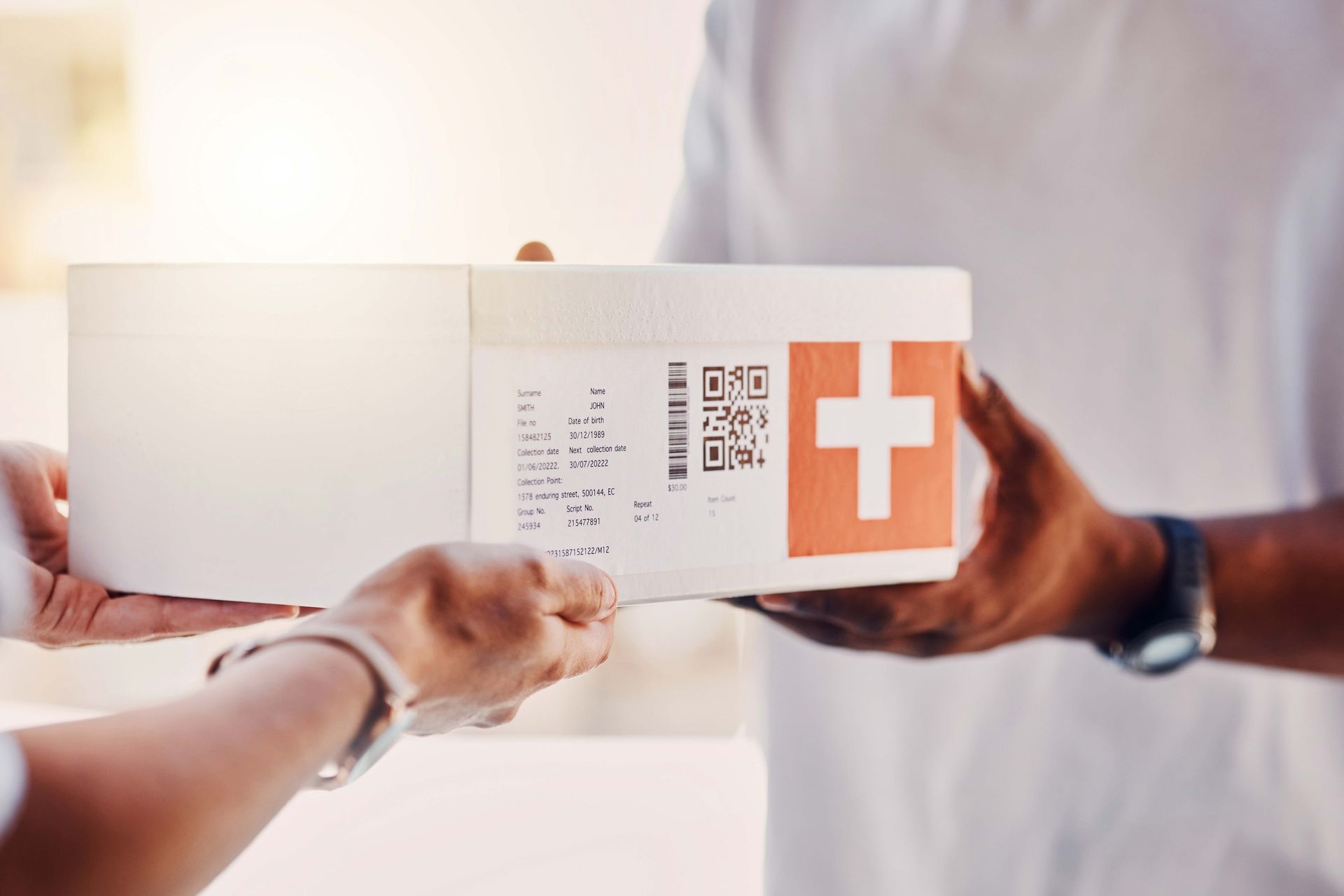 Close-up of a client receiving a box from a courier, showcasing a healthcare courier service. Close-up of a client receiving a box from a courier, showcasing a healthcare courier service.