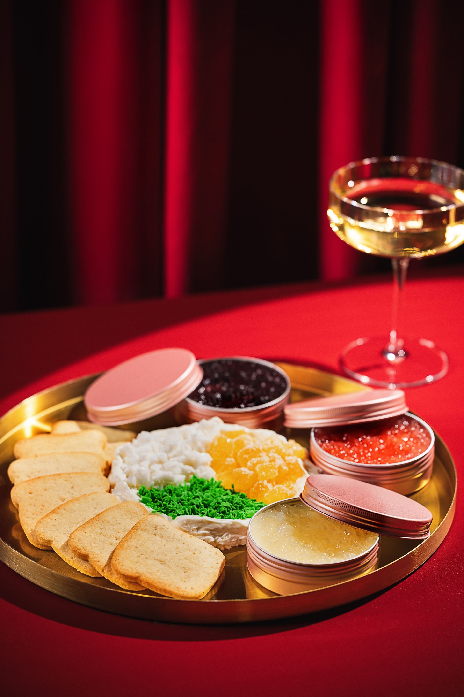 A plate of food and a glass of wine on a table.