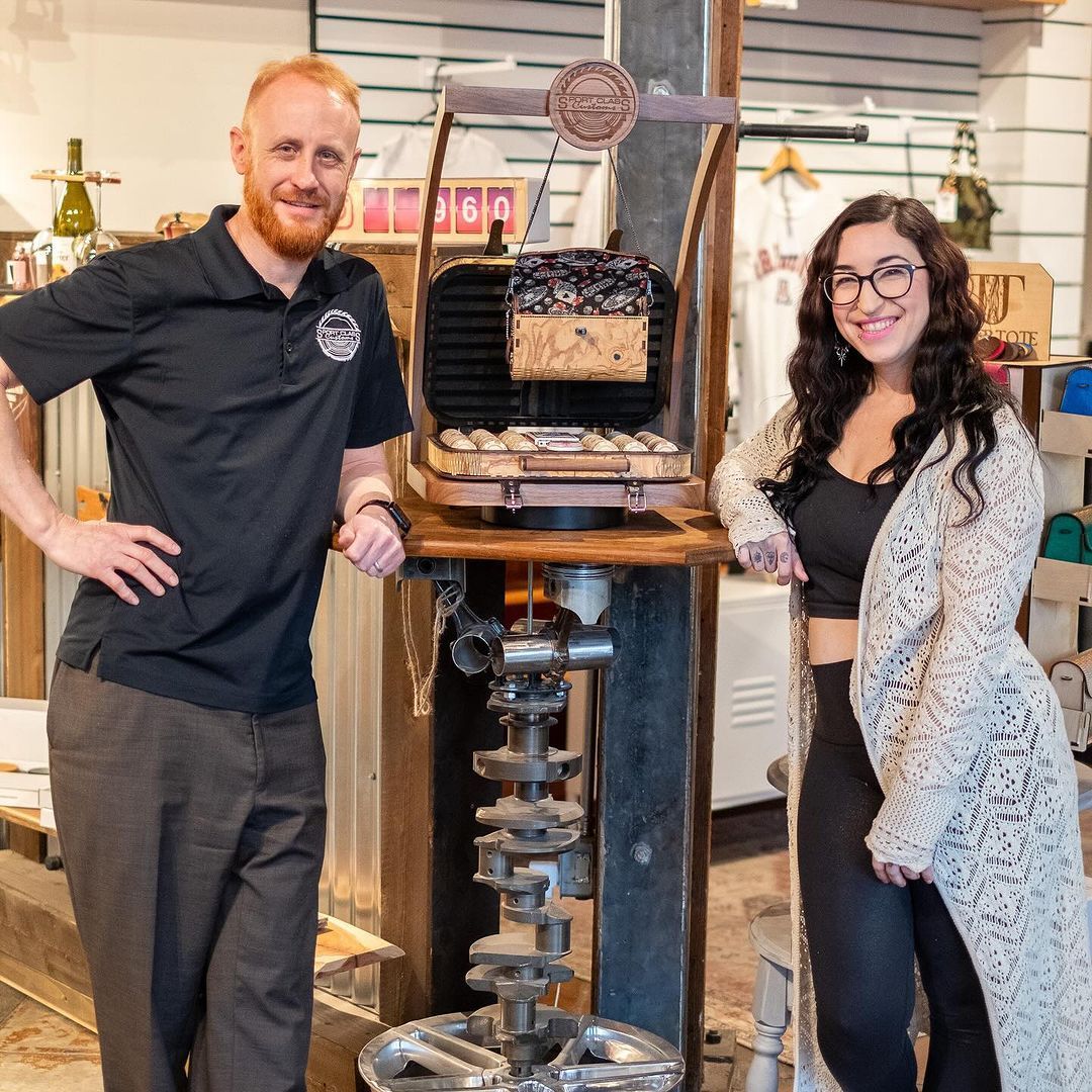 A man and a woman are posing for a picture in a store.