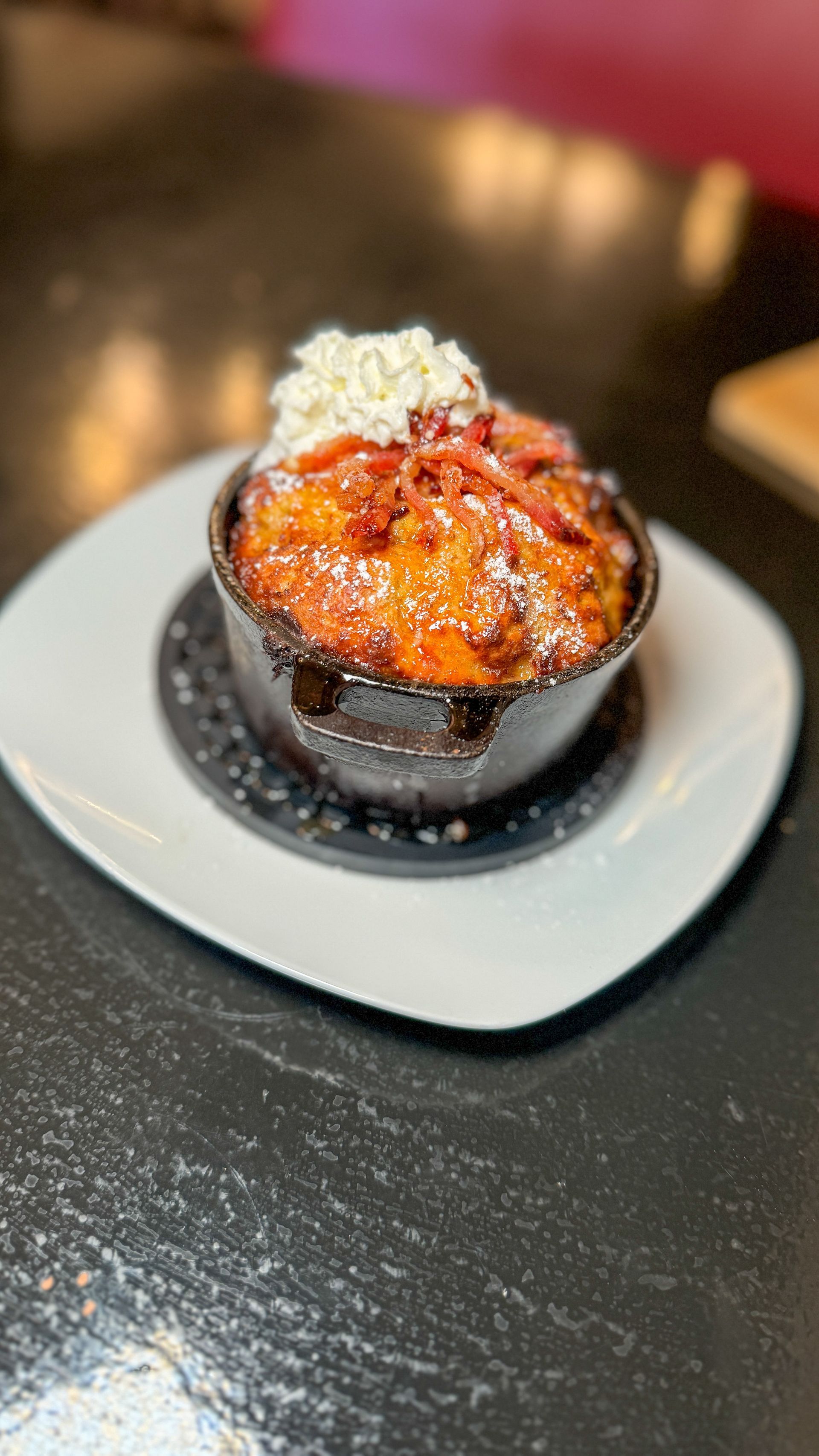 A close up of a dessert on a plate on a table.