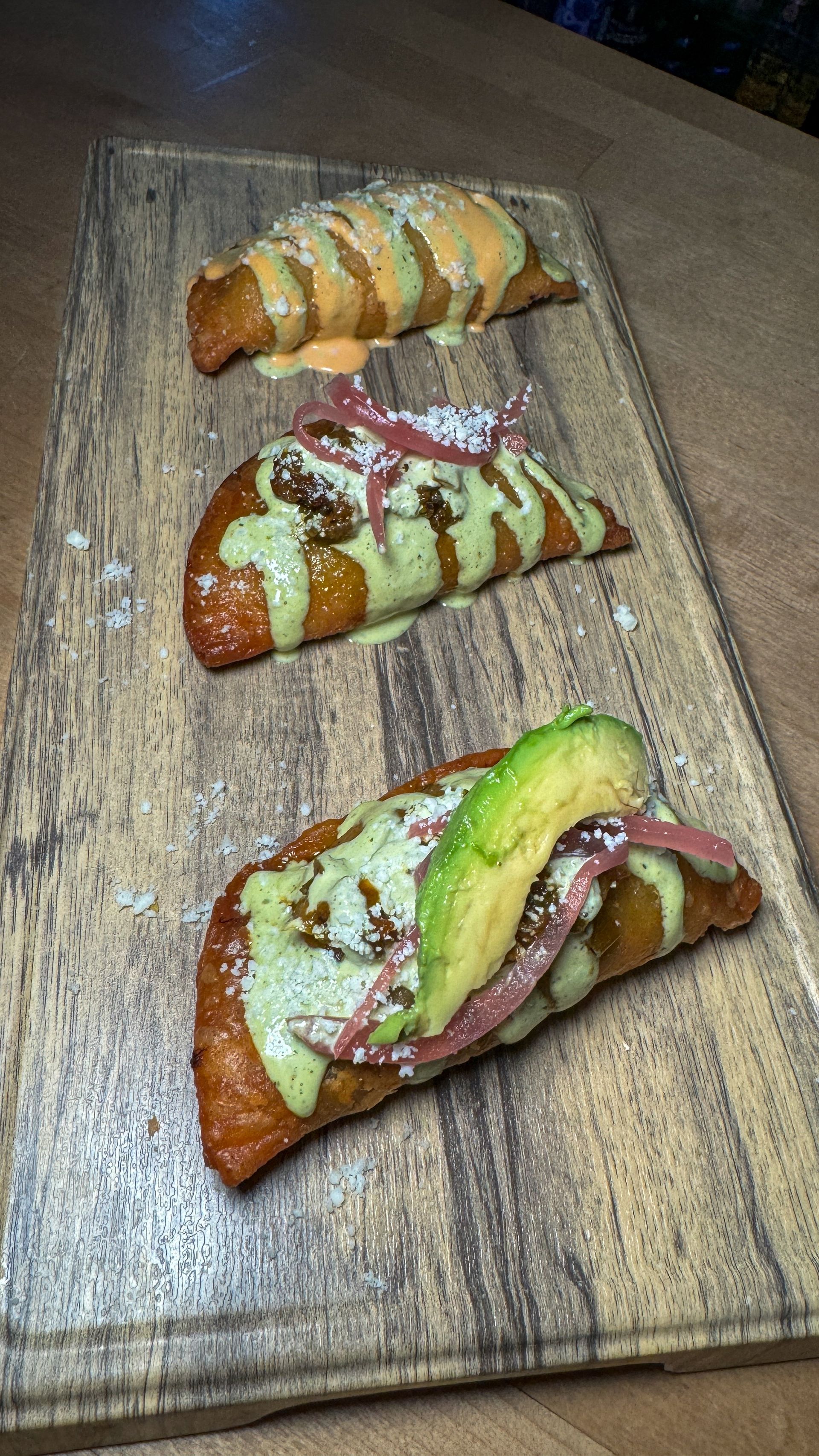 A wooden cutting board topped with three different types of food.
