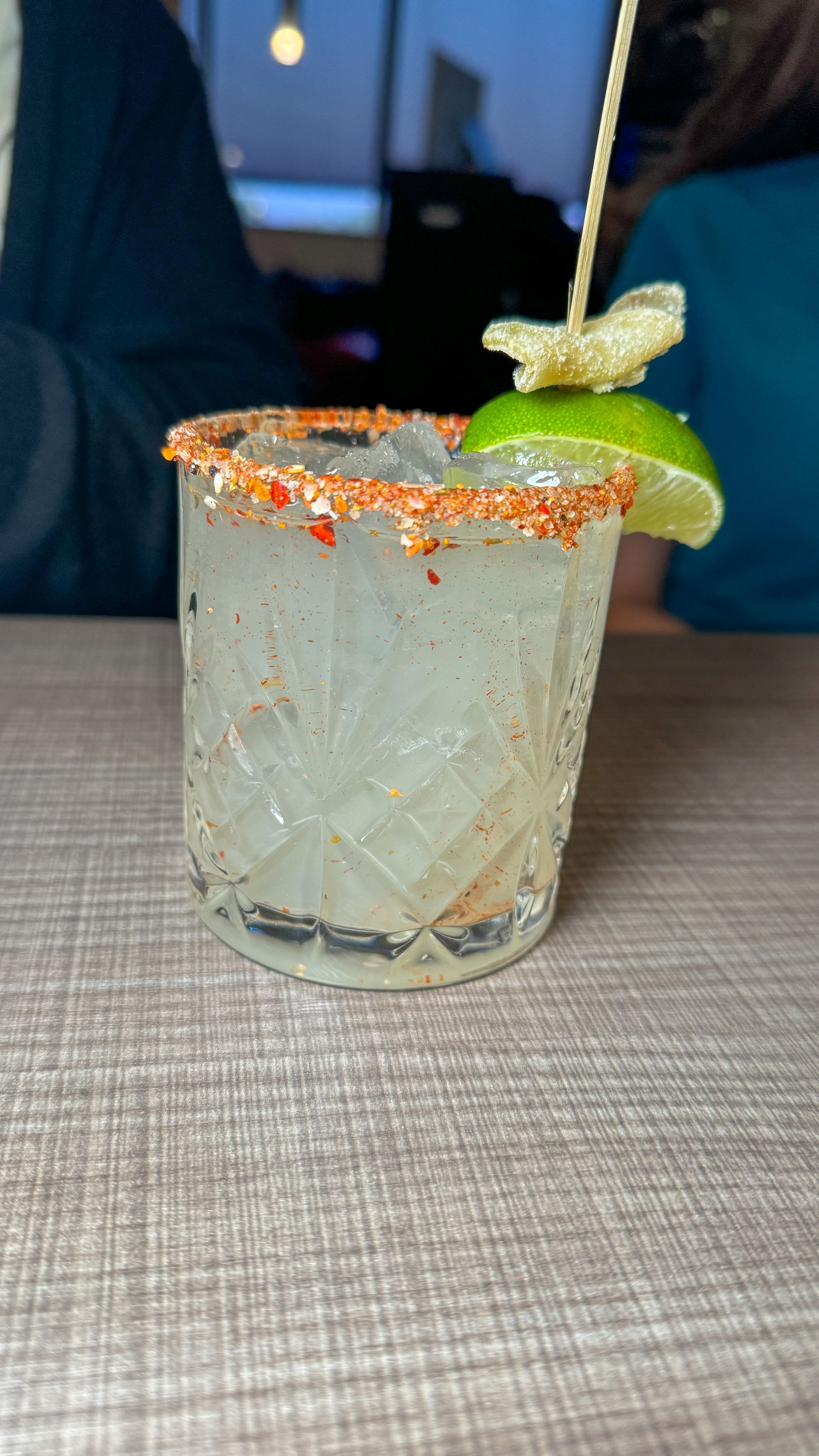 A close up of a drink in a glass on a table.