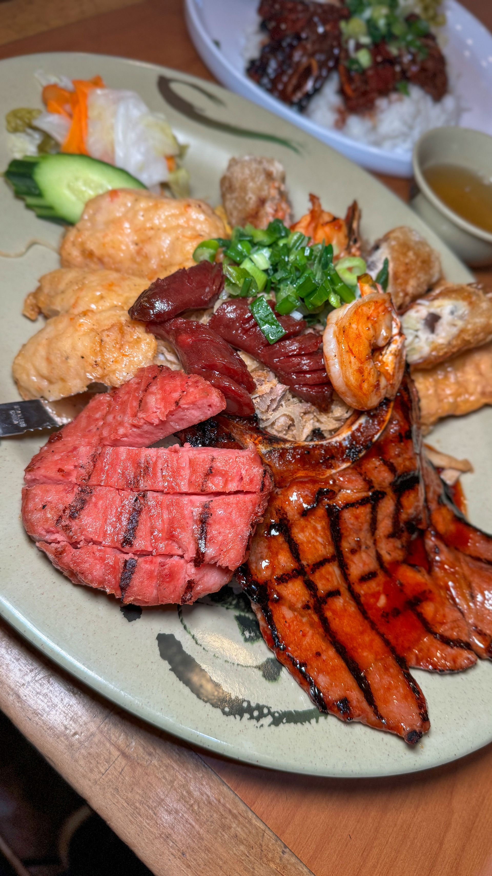 A plate of food with meat and vegetables on a table.