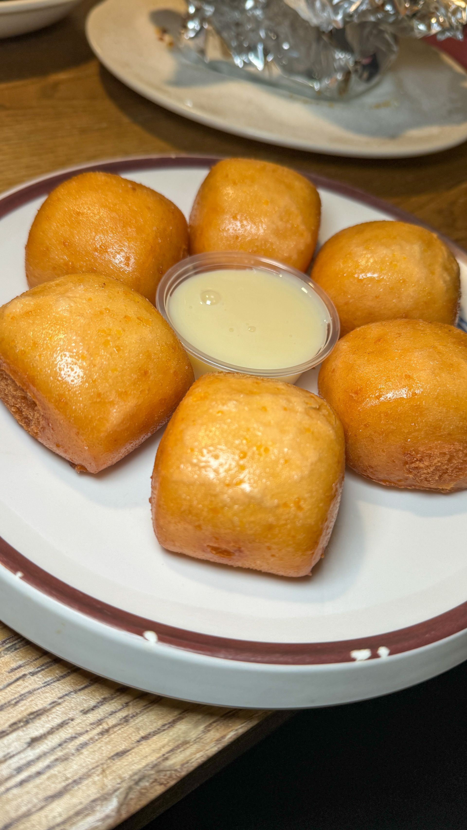 A plate of food with a dipping sauce on a table.
